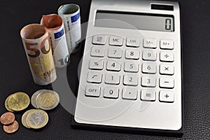 Calculator, euro bills and coins