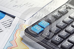 calculator and financial charts. Investment and capital accumulation concept