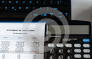 Calculator on financial papers at the table close up