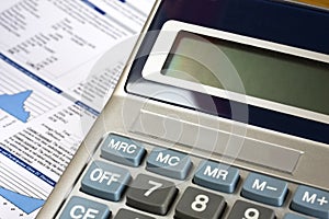 Calculator and financial report as background.