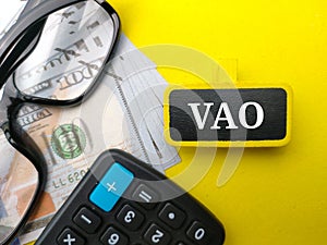 Calculator,glasses and banknotes with word VOA photo