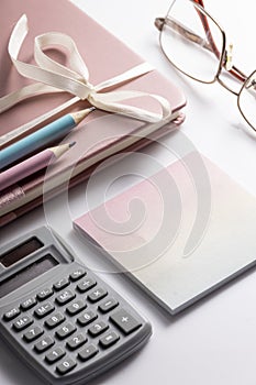 Calculator, glasses, pen and notebook on the table, financial organizer concept