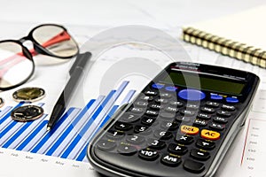 Calculator on graph for business and financial concept. photo
