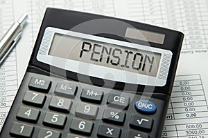 Calculator with the inscription on the PENSION display on the paper tables. Pension calculation