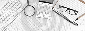 Calculator, keyboard, magnifying glass, pen, eye glasses lying on financial documents . Financial and business concept. Top view