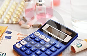 Calculator, medicines and euro bills