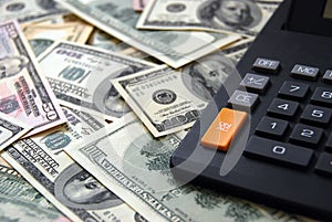 Calculator on money background