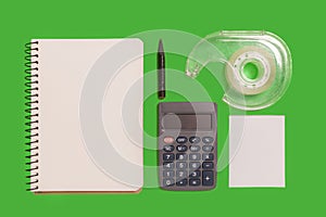 Calculator, notebook, adhensive tape and a pencil photo