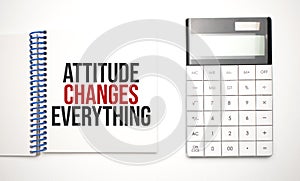 calculator and notepad with text Attitude Changes Everything