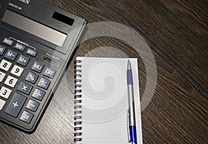 Calculator and Notepad. Top View of Calculator, Notepad with Pen, Personal Income Planning. Financial Concept