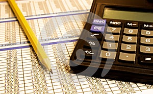 Calculator and pen on bank account passbook, stock photo
