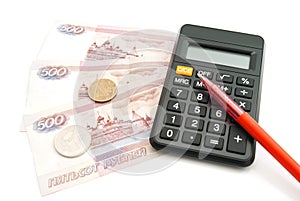 Calculator, pen, banknotes and coins