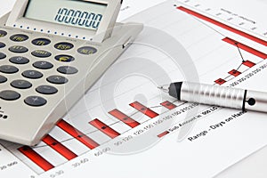 Calculator, pen and Business Chart