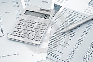 Calculator and Pen on and credit card statements