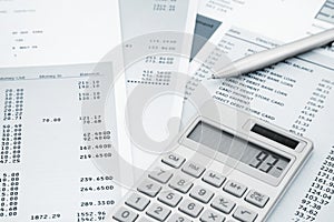 Calculator and Pen on and credit card statements