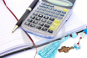 Calculator, pen and notebook