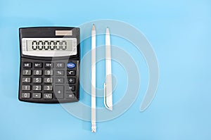 Calculator, pen and pencil on a blue background. Zeros on a calculator scoreboard. Crisis concept / bankrupt / no money. Copy of s