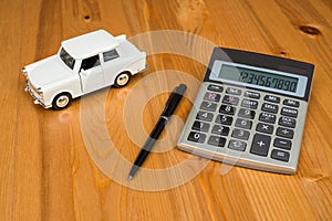 Calculator, a pen and a toy car