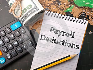 Calculator,pencil and banknotes with the word Payroll Deduction