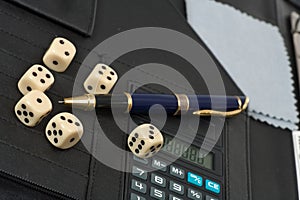 Calculator, pens, dice and financial concept