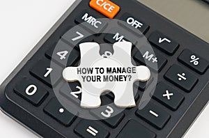 On the calculator is a puzzle with the inscription - How to manage your money