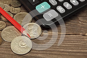 Calculator, red pencil and old coins of the USSR lie on a wooden table. Close-up. Selective focus.