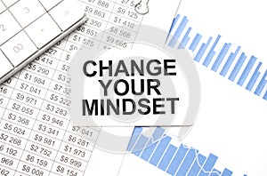 calculator,reports and card with text CHANGE YOUR MINDSET