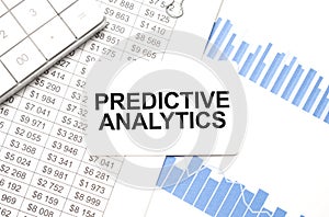 calculator,reports and card with text PREDICTIVE ANALYTICS photo