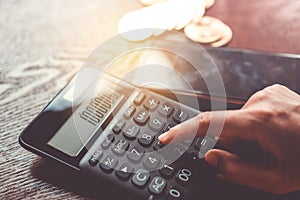 Calculator and a stack of Bitcoins coins as symbol of cryptocurrency digital money in the future blockchain