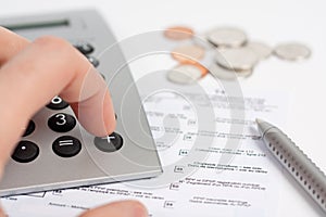 Calculator, Tax Form, Pen and Coins