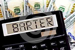Calculator with text BARTER on the dollars. Business, finance conceptual