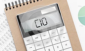 Calculator with text cio with craft colored notepad pen and financial documents