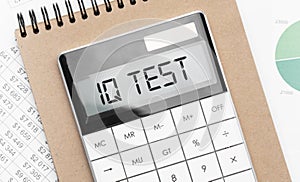 Calculator with text iq test with craft colored notepad pen and financial documents