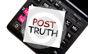 calculator with text POST TRUTH with white paper