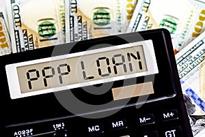 Calculator with text PPP LOAN on the dollars. Business, finance conceptual
