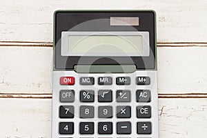 Calculator on wood background