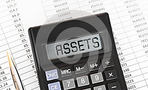 Calculator with the word Assets on the display