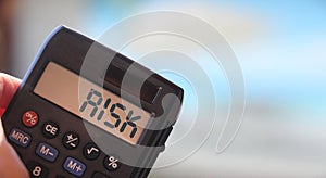 Calculator with the word risk on the display. Investment business concept