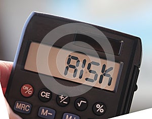 Calculator with the word risk on the display. Investment business concept