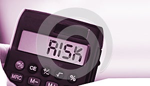 Calculator with the word risk on the display. Investment business concept