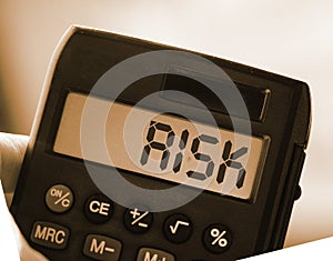 Calculator with the word risk on the display. Investment business concept