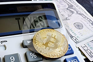 Calculator with word taxes and cryptocurrency coin. Crypto taxation.