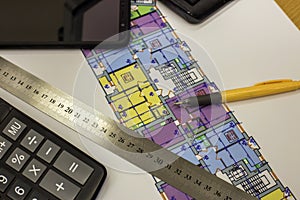 Calcurator, pen and ruler on building house architecture plan drawing blueprint. Planning, measurement and investments concept