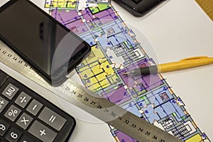 Calcurator, pen and ruler on building house architecture plan drawing blueprint. Planning, measurement and investments concept