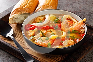 Caldeirada de frutos do mar Portuguese seafood stew with potatoes, peppers, tomatoes and onions close-up in a bowl. horizontal photo