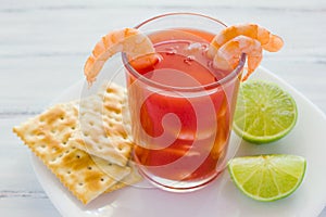 Caldo de camaron, consome de camarones, Shrimp cocktail with lemon and salted cookies mexican sea food in mexico photo