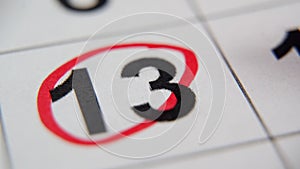 The calendar 13th of the month is circled. A red marker circles the thirteenth day of the month from the paper calendar