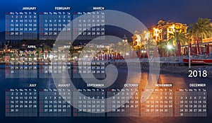 Calendar 2018 in English. Week starts on sunday. Portofino village. Santa Margherita Ligure by night in Italy