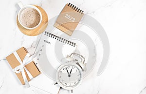 Calendar 2023 and alarm clock on office table. to-do list and plan for next year. flatlay composition