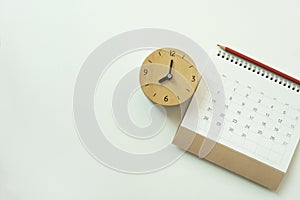 Calendar and alarm clock on the white table background, planning for business meeting or travel planning concept